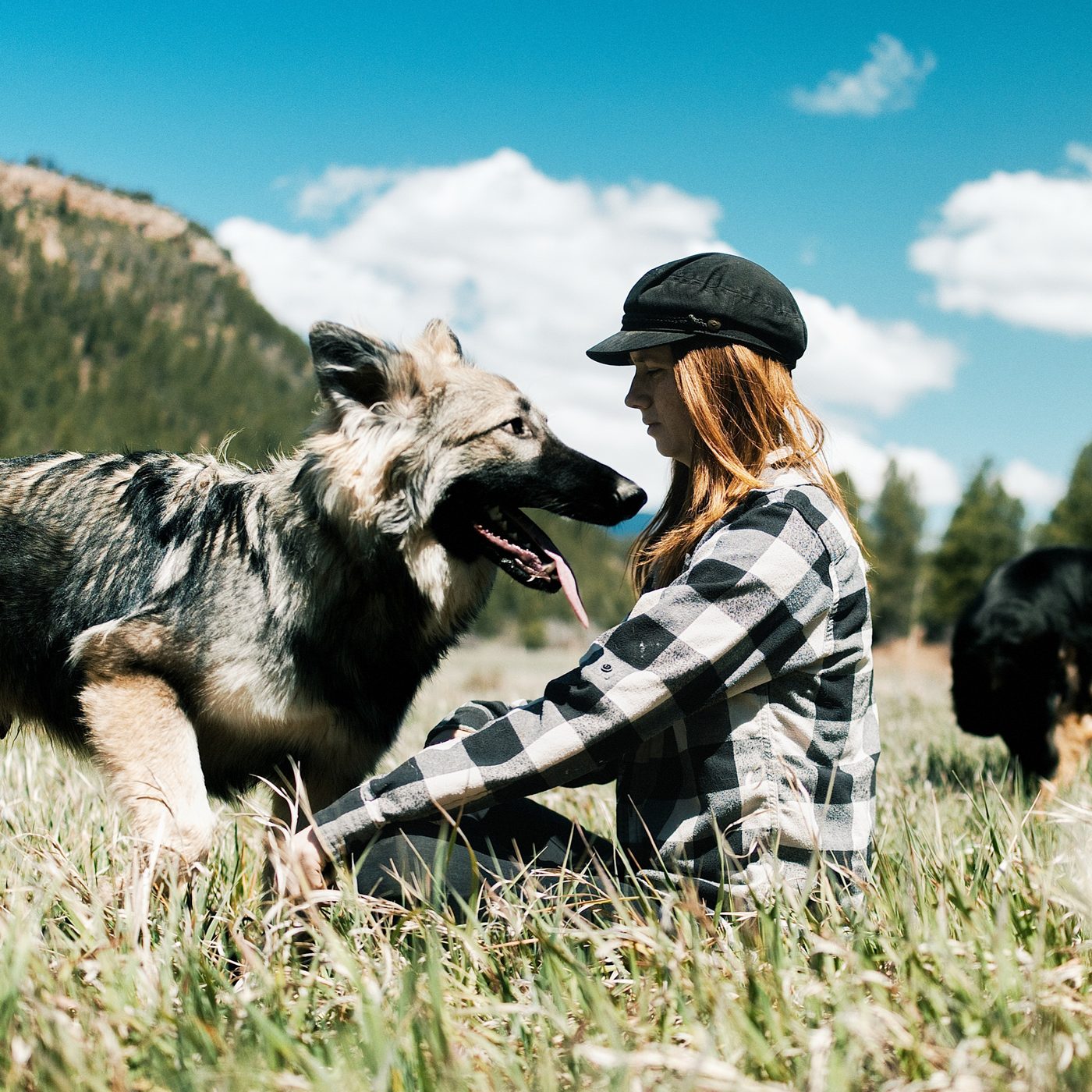 Hannah Rousseau with one of her German Shepherds in the Rocky Mountains